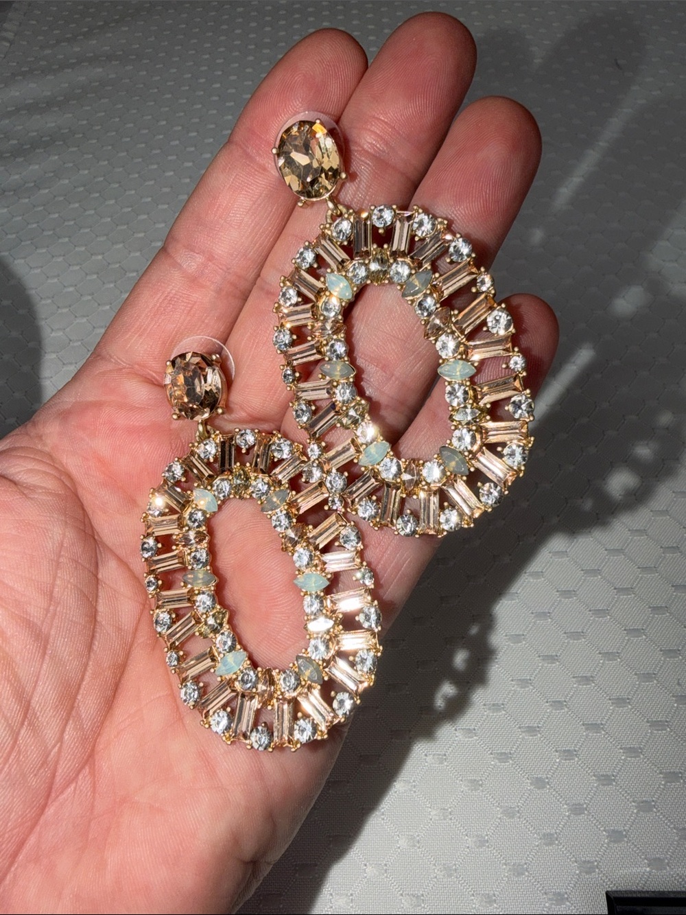 Ettika Gold and Clear Crystal Oval Drop Earrings with opal colored stones mixed